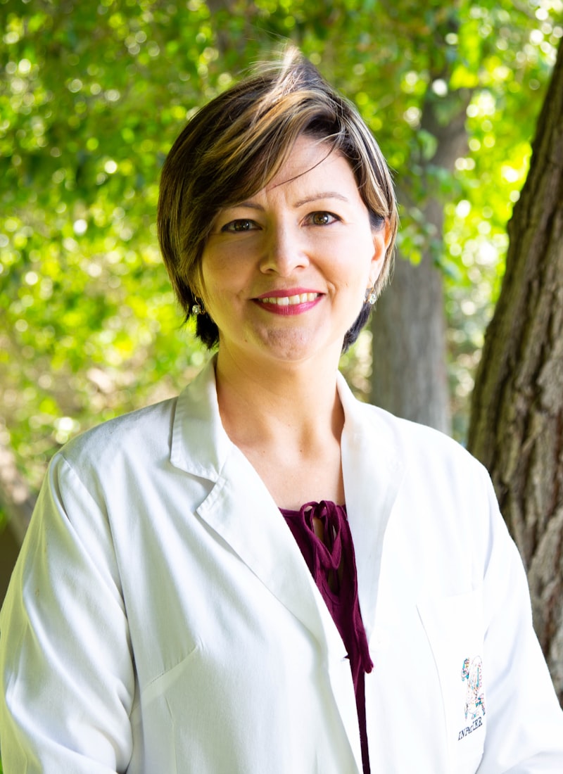 A doctor in a white coat outside her practice